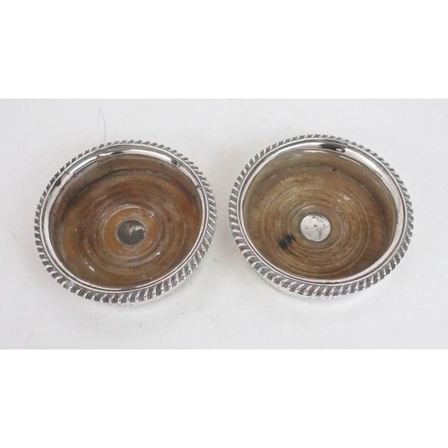 2481 - A MATCHED PAIR OF GEORGE IV SILVER WINE COASTERSwith gadrooned rims and turned wooden inserts, with ... 