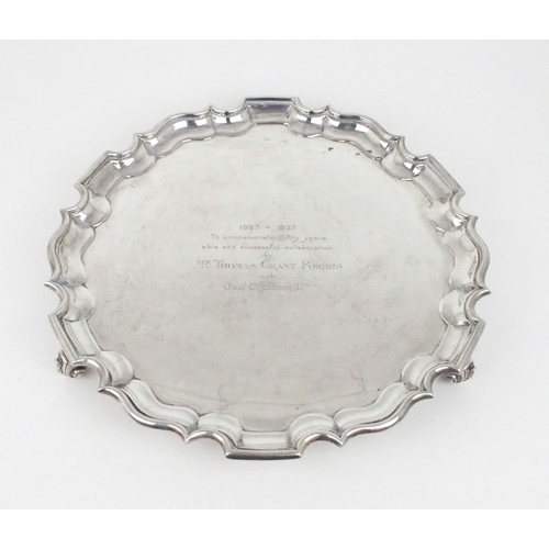 2490 - A GEORGE V SILVER SALVERof plain form, with a chippendale pie crust border, engraved to the centre '... 