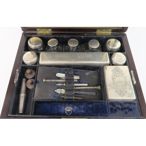 2493 - A VICTORIAN BRASS BOUND MAHOGANY TRAVELLING TOILETRY BOXcomprising silver topped vanity jars and sce... 