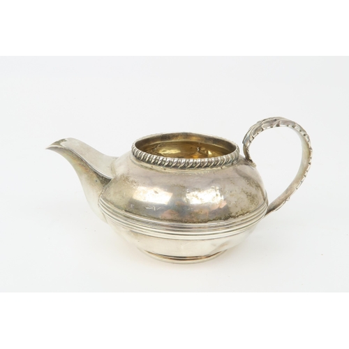 2494 - A GEORGE III SILVER CREAM JUGof teapot form, with central banding, a gadrooned rim and acanthus leaf... 