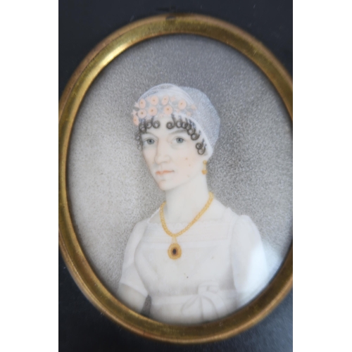 2598 - THREE REGENCY PORTRAIT MINIATURES PAINTED ON IVORYIn ebonised frames, comprising a lady with ringlet... 