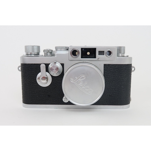 2613 - A LEITZ LEICA IIIg CAMERASerial no. 981 351, fitted with a Leitz Elmar lens (no. 1635730), housed in... 