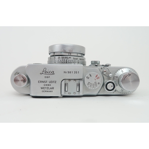 2613 - A LEITZ LEICA IIIg CAMERASerial no. 981 351, fitted with a Leitz Elmar lens (no. 1635730), housed in... 