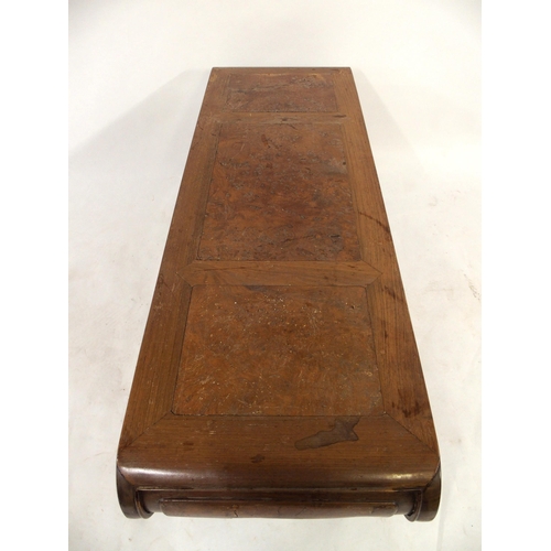 2004 - A 20TH CENTURY CHINESE HARDWOOD LOW TABLEwith top terminating in scrolled ends over carved frieze an... 