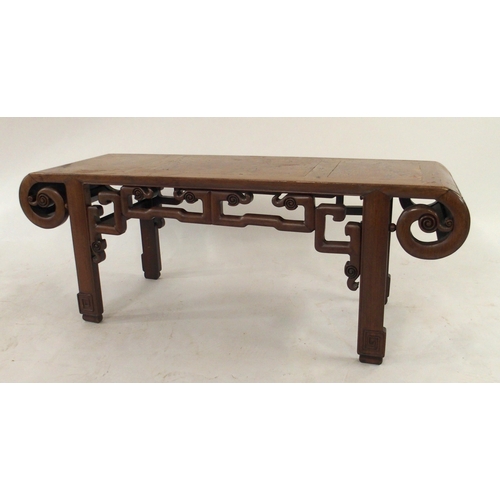 2004 - A 20TH CENTURY CHINESE HARDWOOD LOW TABLEwith top terminating in scrolled ends over carved frieze an... 