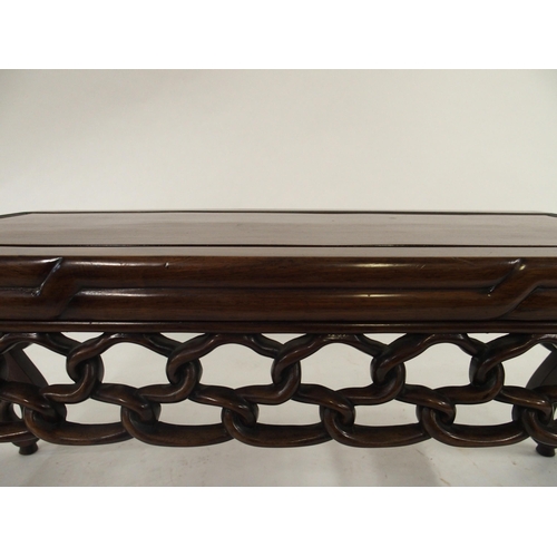 2006 - A 20TH CENTURY CHINESE HARDWOOD LOW TABLEwith carved fretwork bowed ends and friezes, 41cm high x 10... 