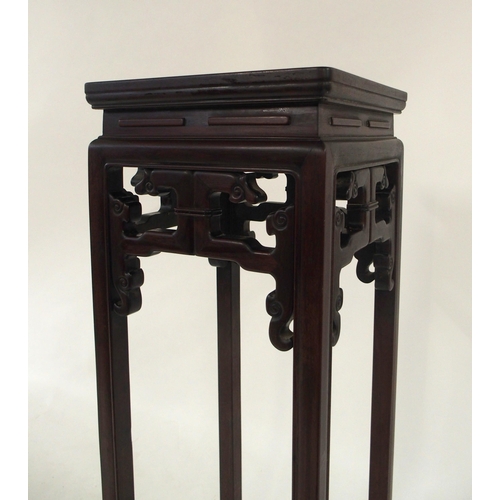 2007 - A 20TH CENTURY CHINESE HARDWOOD PLANT PEDESTALwith square top over carved fretwork friezes on shaped... 