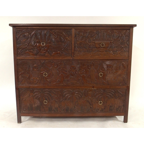 2010 - A 20TH CENTURY AFRICAN HARDWOOD TWO OVER TWO CHEST OF DRAWERS with extensively carved drawer facings... 