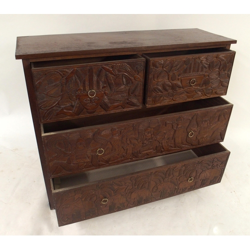 2010 - A 20TH CENTURY AFRICAN HARDWOOD TWO OVER TWO CHEST OF DRAWERS with extensively carved drawer facings... 