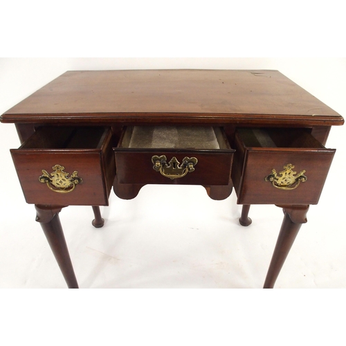 2029 - A GEORGIAN MAHOGANY LOWBOYwith three short drawers with brass drawer pulls over shaped frieze on tur... 