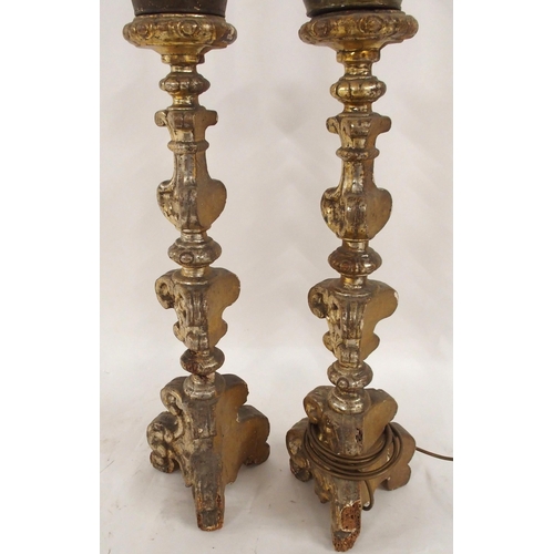 2032 - A PAIR OF 18TH CENTURY STYLE GILTWOOD AND GESSO CANDLESTICKS converted as lamps, with painted drip t... 