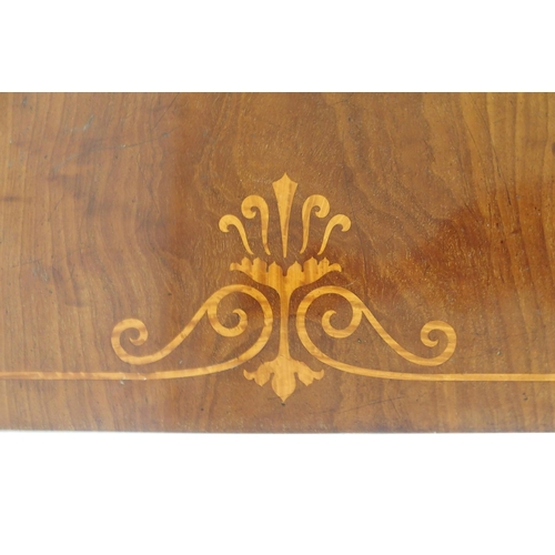 2038 - A VICTORIAN MAHOGANY AND SATINWOOD INLAID LIBRARY TABLEwith carved friezes on carved lyre shaped sup... 