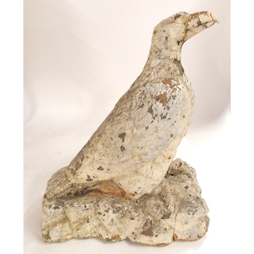 2039 - A 19TH/20TH CENTURY STONECAST STATUE OF AN EAGLE PERCHED ON ROCKSpainted white, 56cm high... 