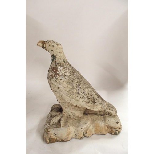 2039 - A 19TH/20TH CENTURY STONECAST STATUE OF AN EAGLE PERCHED ON ROCKSpainted white, 56cm high... 