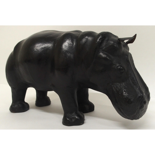 2042 - AN EARLY 20TH CENTURY LIBERTY OF LONDON STYLE LEATHER HIPPOPOTAMUS FOOTSTOOLwith glass eyes, 32cm hi... 