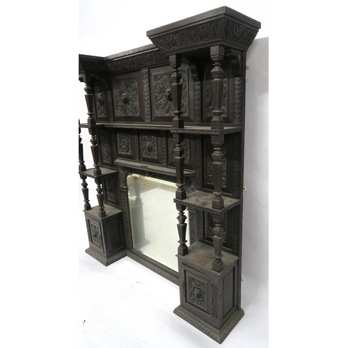 2050 - A VICTORIAN STAINED OAK BARONIAL STYLE OVERMANTLE MIRRORwith shaped bevelled glass mirror flanked by... 