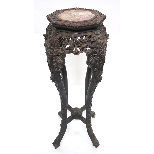 2051 - A 19TH CENTURY CHINESE HARDWOOD PLANT PEDESTALwith octagonal top with marble insert over carved pier... 