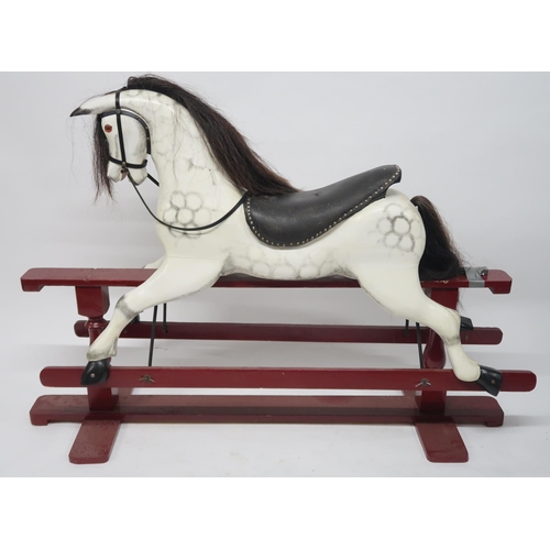 2055 - A 20TH CENTURY DAPPLE GREY PAINTED ROCKING HORSEwith black leather saddle and reigns, horse hair man... 