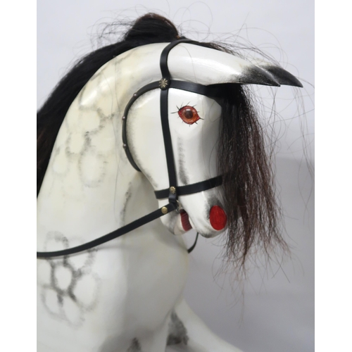 2055 - A 20TH CENTURY DAPPLE GREY PAINTED ROCKING HORSEwith black leather saddle and reigns, horse hair man... 
