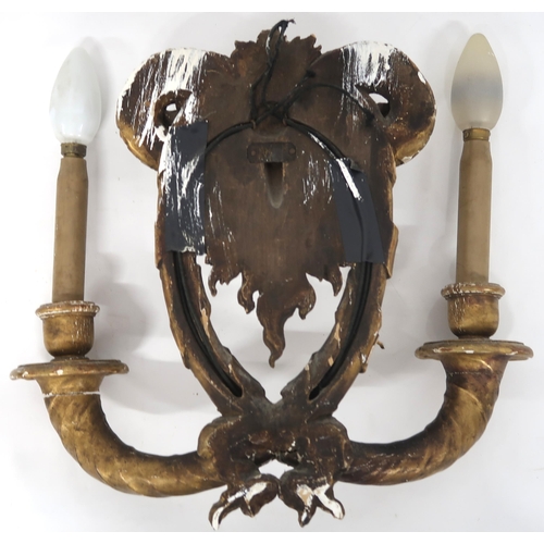 2063 - A PAIR OF GILT GESSO TWO BRANCH WALL SCONCESeach sconce modelled with rams heads over branches with ... 