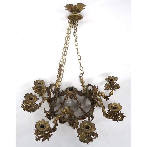 2064 - A REGENCY STYLE GILT METAL EIGHT BRANCH ROCOCO STYLE CANDELABRAwith central moulded frosted glass sh... 