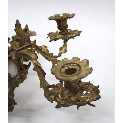 2064 - A REGENCY STYLE GILT METAL EIGHT BRANCH ROCOCO STYLE CANDELABRAwith central moulded frosted glass sh... 