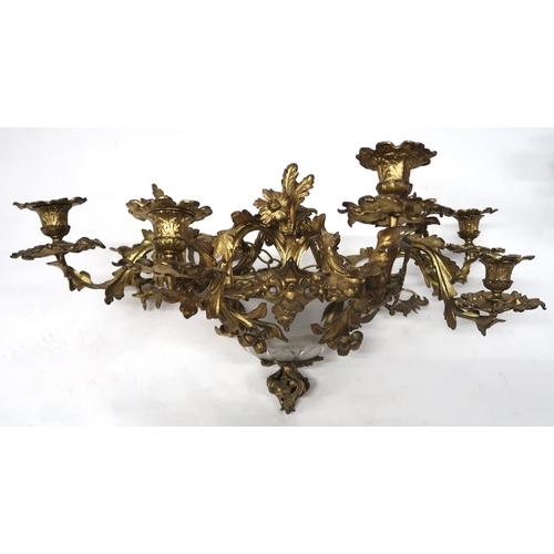 2064 - A REGENCY STYLE GILT METAL EIGHT BRANCH ROCOCO STYLE CANDELABRAwith central moulded frosted glass sh... 