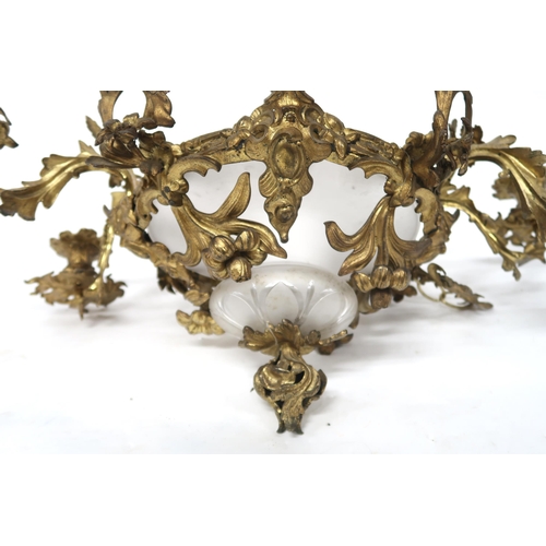 2064 - A REGENCY STYLE GILT METAL EIGHT BRANCH ROCOCO STYLE CANDELABRAwith central moulded frosted glass sh... 