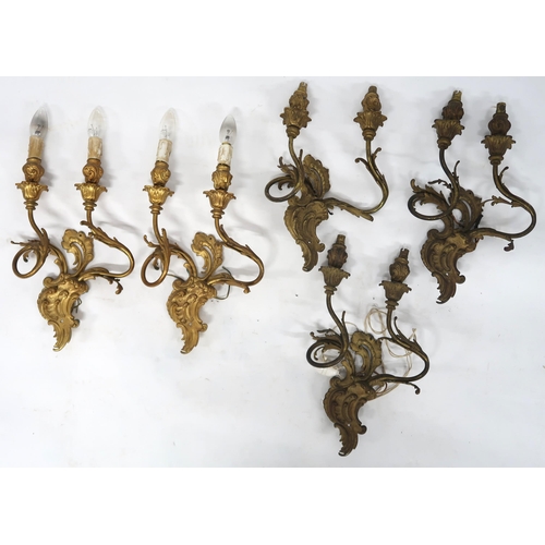 2066 - A LOT OF FIVE ROCOCO STYLE GILT METAL ORMOLU TWO BRANCH WALL SCONCESwith scroll and acanthus back pl... 