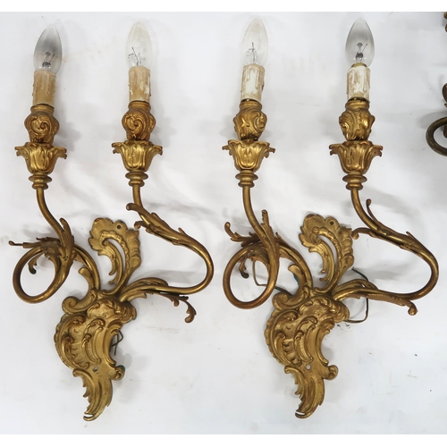 2066 - A LOT OF FIVE ROCOCO STYLE GILT METAL ORMOLU TWO BRANCH WALL SCONCESwith scroll and acanthus back pl... 