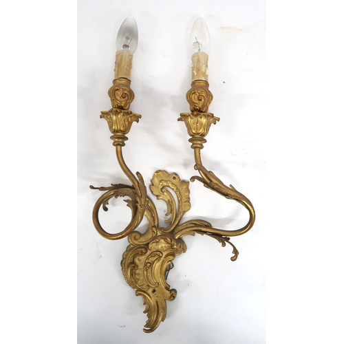 2066 - A LOT OF FIVE ROCOCO STYLE GILT METAL ORMOLU TWO BRANCH WALL SCONCESwith scroll and acanthus back pl... 