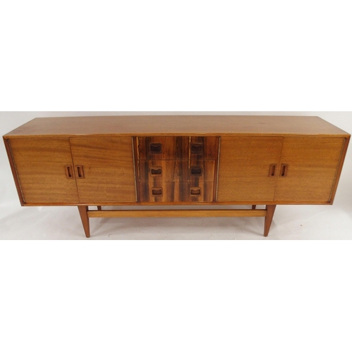 2105 - *WITHDRAWN* A MID 20TH CENTURY ROSEWOOD AND TEAK SIDEBOARDwith three rosewood veneered central drawe... 