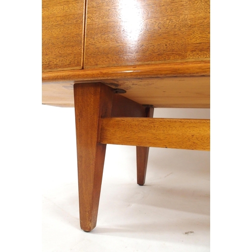 2105 - *WITHDRAWN* A MID 20TH CENTURY ROSEWOOD AND TEAK SIDEBOARDwith three rosewood veneered central drawe... 