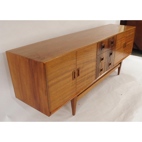 2105 - *WITHDRAWN* A MID 20TH CENTURY ROSEWOOD AND TEAK SIDEBOARDwith three rosewood veneered central drawe... 