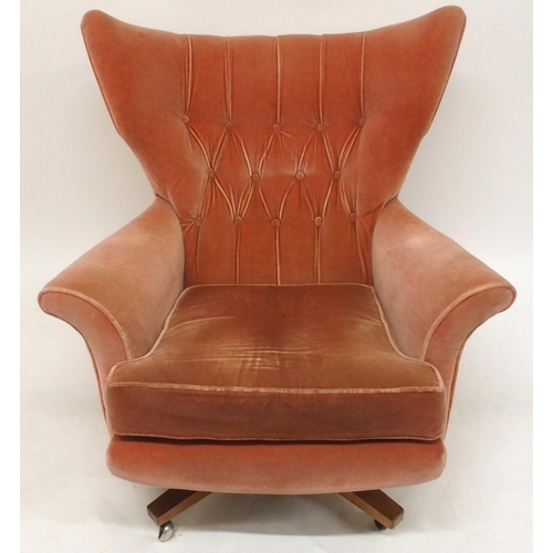 2106 - A MID 20TH CENTURY G PLAN MODEL 6250 SWIVEL WING BACK ARMCHAIRwith pick velour button back upholster... 