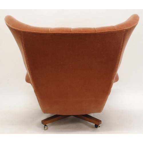 2106 - A MID 20TH CENTURY G PLAN MODEL 6250 SWIVEL WING BACK ARMCHAIRwith pick velour button back upholster... 