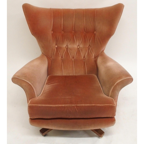 2107 - A MID 20TH CENTURY G PLAN MODEL 6250 SWIVEL WING BACK ARMCHAIRwith pick velour button back upholster... 