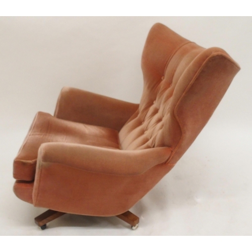 2107 - A MID 20TH CENTURY G PLAN MODEL 6250 SWIVEL WING BACK ARMCHAIRwith pick velour button back upholster... 