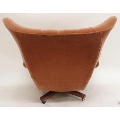 2107 - A MID 20TH CENTURY G PLAN MODEL 6250 SWIVEL WING BACK ARMCHAIRwith pick velour button back upholster... 