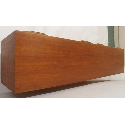 2108 - A MID 20TH CENTURY TEAK A.H. MCINTOSH OF KIRKCALDY SIDEBOARDwith pair of cabinet doors flanked by th... 