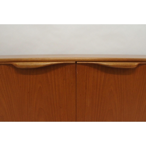 2108 - A MID 20TH CENTURY TEAK A.H. MCINTOSH OF KIRKCALDY SIDEBOARDwith pair of cabinet doors flanked by th... 