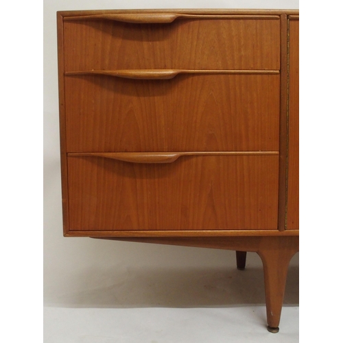 2108 - A MID 20TH CENTURY TEAK A.H. MCINTOSH OF KIRKCALDY SIDEBOARDwith pair of cabinet doors flanked by th... 