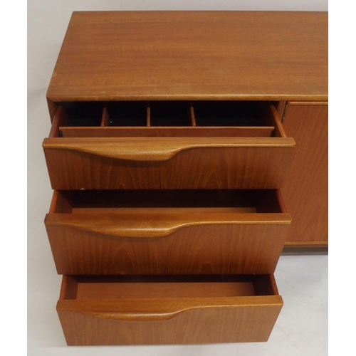 2108 - A MID 20TH CENTURY TEAK A.H. MCINTOSH OF KIRKCALDY SIDEBOARDwith pair of cabinet doors flanked by th... 