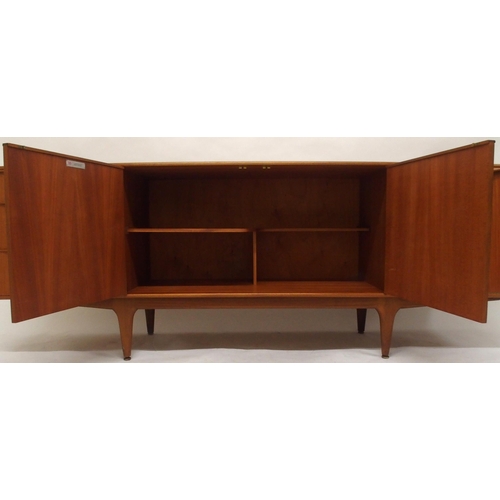 2108 - A MID 20TH CENTURY TEAK A.H. MCINTOSH OF KIRKCALDY SIDEBOARDwith pair of cabinet doors flanked by th... 