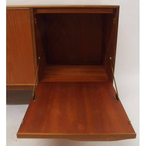 2108 - A MID 20TH CENTURY TEAK A.H. MCINTOSH OF KIRKCALDY SIDEBOARDwith pair of cabinet doors flanked by th... 