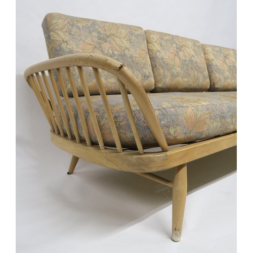 2111 - A MID 20TH CENTURY ELM AND BEECH FRAMED ERCOL DAY BEDwith floral upholstered cushions, 77cm high x 2... 