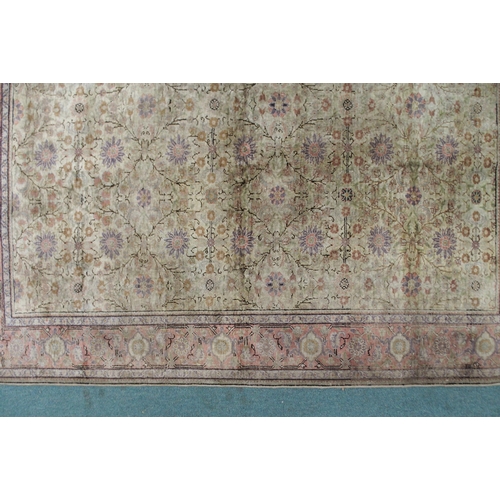 2131 - A CREAM GROUND SILK AND WOOL PERSIAN RUGwith floral foliate all-over design and pink borders, 185cm ... 