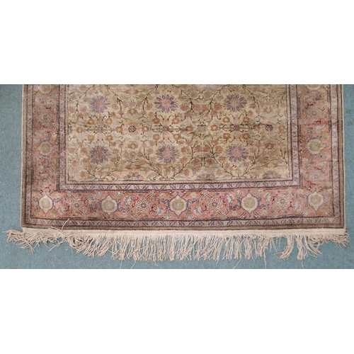 2131 - A CREAM GROUND SILK AND WOOL PERSIAN RUGwith floral foliate all-over design and pink borders, 185cm ... 