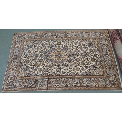 2133 - A CREAM GROUND KASHAN RUGwith blue diamond central medallion, matching spandrels and flower head bor... 