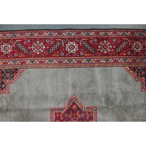 2134 - A GREEN GROUND TABRIZ RUGwith red geometric central medallion, dark blue and white spandrels and fol... 